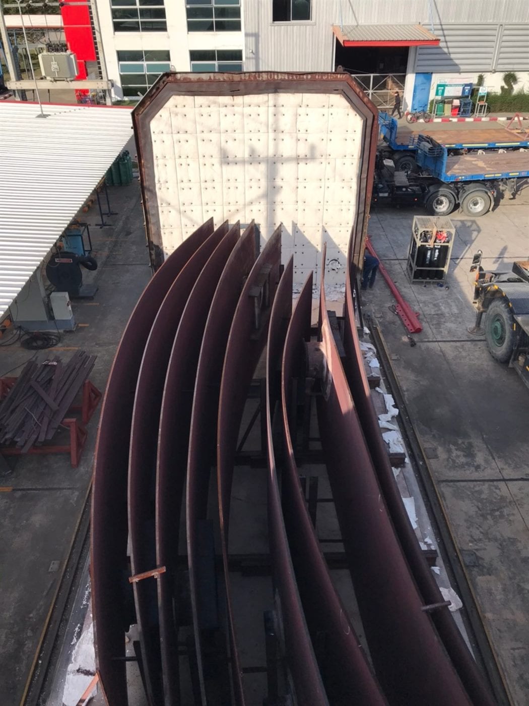 Fabricated steel components being lifted into a heat treatment furnace