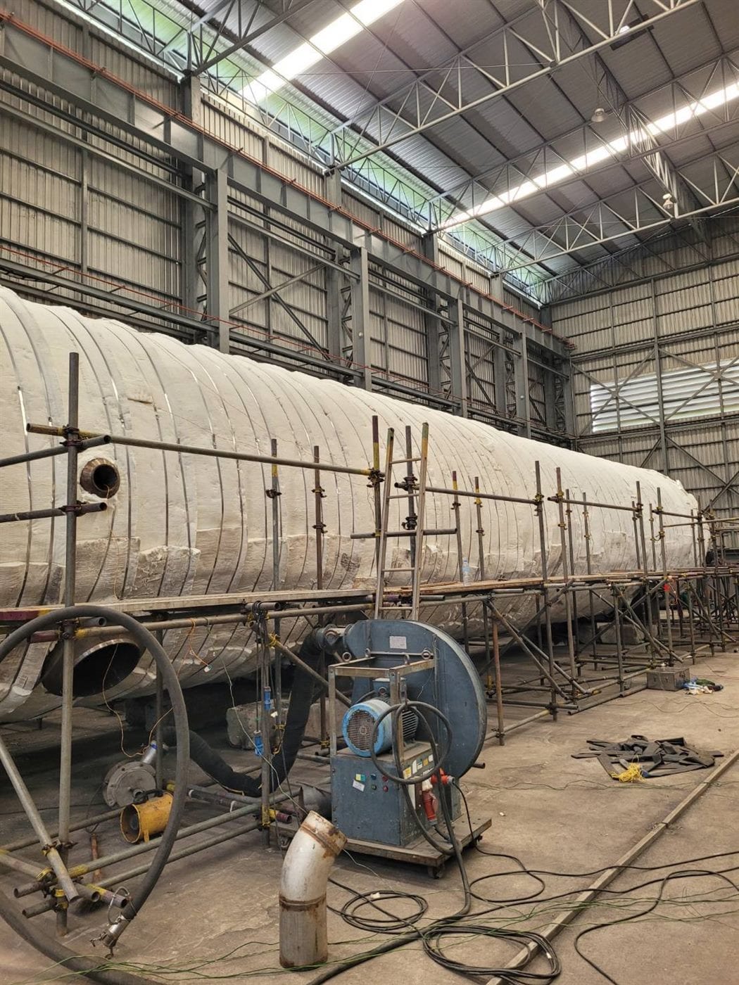 Post Weld Heat Treatment in progress — JST technician monitoring PWHT data logger on pipe weld