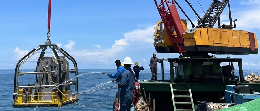 Vibro-corer frame being deployed from the deck of a survey vessel