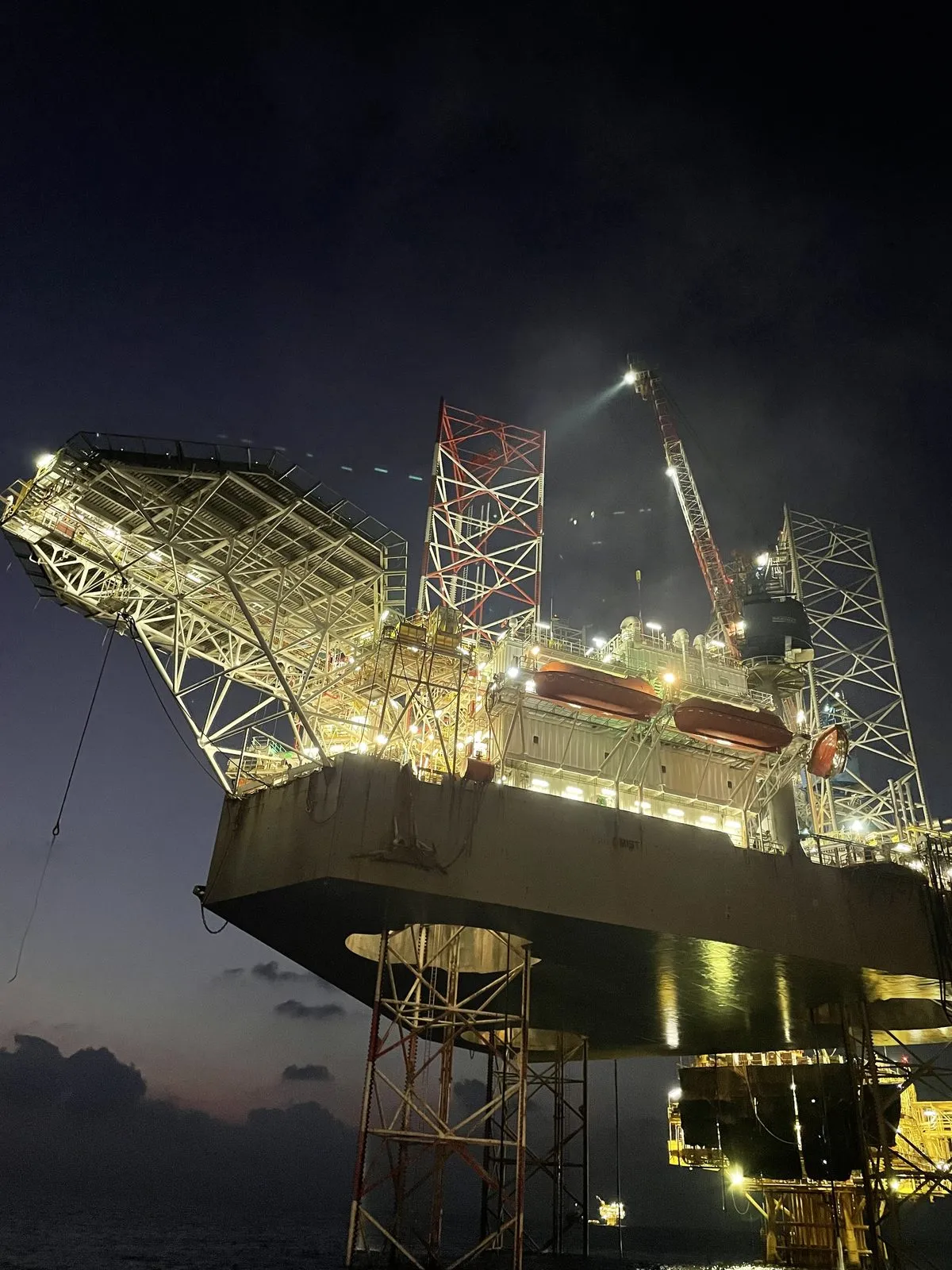Jack-up rig lit up offshore at night